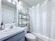Bathroom featuring a shower/tub combo, towels on a metal shelving unit, and a vanity at 458 Hollinghead Loop, Davenport, FL 33896