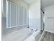 Modern bathroom featuring a soaking tub, shower, and stylish fixtures at 458 Hollinghead Loop, Davenport, FL 33896