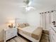 Bedroom featuring a ceiling fan, light wood floors, and modern furniture at 458 Hollinghead Loop, Davenport, FL 33896