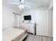 Well-lit bedroom with TV, dresser, and a ceiling fan at 458 Hollinghead Loop, Davenport, FL 33896