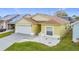 Charming home featuring a well-maintained lawn, two-car garage, and neutral color scheme at 458 Hollinghead Loop, Davenport, FL 33896