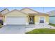 Well-kept home with a two-car garage and a simple, clean landscaped yard at 458 Hollinghead Loop, Davenport, FL 33896