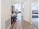 Hallway view with plank floors and decor that leads to the living spaces and bedrooms at 458 Hollinghead Loop, Davenport, FL 33896