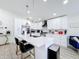 Modern kitchen with stainless steel appliances, sleek white cabinets, and a spacious island at 458 Hollinghead Loop, Davenport, FL 33896