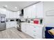 Well-appointed kitchen featuring white cabinets, stainless steel appliances, and stylish finishes at 458 Hollinghead Loop, Davenport, FL 33896