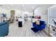 Bright kitchen open to the living area, featuring white cabinetry and modern appliances at 458 Hollinghead Loop, Davenport, FL 33896