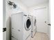 Efficient laundry room with modern washer and dryer units at 458 Hollinghead Loop, Davenport, FL 33896