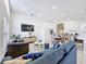 Open-concept living and dining area with modern furniture and plenty of natural light at 458 Hollinghead Loop, Davenport, FL 33896