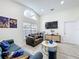 Cozy living room with high ceilings, ample natural light, and stylish decor at 458 Hollinghead Loop, Davenport, FL 33896