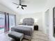 Stylish main bedroom with a luxurious bed, bench seat, and en-suite bathroom at 458 Hollinghead Loop, Davenport, FL 33896