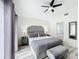 Charming main bedroom boasts soft decor, en-suite bathroom, and plenty of natural light at 458 Hollinghead Loop, Davenport, FL 33896