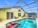 Relaxing screened-in pool area with inviting furniture and clear blue water, perfect for outdoor enjoyment at 458 Hollinghead Loop, Davenport, FL 33896