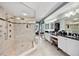 Bathroom featuring a glass-enclosed shower, dual sinks, and vanity area at 4651 S Atlantic Ave # 2030, Ponce Inlet, FL 32127