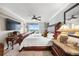 Bright bedroom with a ceiling fan, large television, balcony access, and ocean views at 4651 S Atlantic Ave # 2030, Ponce Inlet, FL 32127