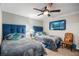 Cozy bedroom with two twin beds, a ceiling fan and decoratively framed ocean scene at 4651 S Atlantic Ave # 2030, Ponce Inlet, FL 32127