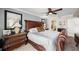 Spacious bedroom featuring a grand bed, elegant furnishings, and access to the bathroom at 4651 S Atlantic Ave # 2030, Ponce Inlet, FL 32127
