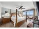 Bedroom with an ocean view, balcony, a four-poster bed, and warm lighting at 4651 S Atlantic Ave # 2030, Ponce Inlet, FL 32127