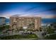 Exterior shot of the condo building at dusk, highlighting its architecture, balconies, and oceanfront location at 4651 S Atlantic Ave # 2030, Ponce Inlet, FL 32127