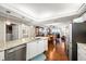 Close-up of a modern kitchen with granite countertops, stainless steel appliances, and an open design to the dining room at 4651 S Atlantic Ave # 2030, Ponce Inlet, FL 32127