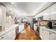 Modern open-concept kitchen with stainless steel appliances, granite countertops, hardwood floors, and open views to dining area at 4651 S Atlantic Ave # 2030, Ponce Inlet, FL 32127