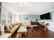 Cozy living room with wood floors, crown molding, comfortable seating, and a wall-mounted TV at 4651 S Atlantic Ave # 2030, Ponce Inlet, FL 32127