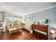 Cozy living room with wood floors, crown molding, comfortable seating, and natural light streaming through the windows at 4651 S Atlantic Ave # 2030, Ponce Inlet, FL 32127