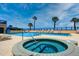 Community pool and hot tub area with tropical palms and ocean views at 4651 S Atlantic Ave # 2030, Ponce Inlet, FL 32127