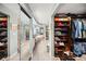 Spacious walk-in closet leading to the primary bathroom featuring plenty of shelving and storage at 4651 S Atlantic Ave # 2030, Ponce Inlet, FL 32127