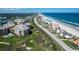 Wide aerial shot showcases oceanfront condos, green golf course, and expansive coastal scenery at 4651 S Atlantic Ave # 2030, Ponce Inlet, FL 32127