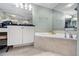 Bright bathroom features a soaking tub with tile surround, and large vanity at 4651 S Atlantic Ave # 2030, Ponce Inlet, FL 32127