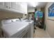 Efficient laundry room with white washer, dryer, and cabinetry for storage at 4651 S Atlantic Ave # 2030, Ponce Inlet, FL 32127