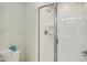 Modern bathroom featuring glass shower door and white tiled walls at 4841 Romeo Cir, Kissimmee, FL 34746