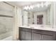 Bathroom featuring double vanity with white countertop and bath tub with shower at 4841 Romeo Cir, Kissimmee, FL 34746