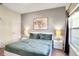 Comfortable bedroom with stylish decor, featuring a queen bed, bedside tables, and ample natural light at 4841 Romeo Cir, Kissimmee, FL 34746