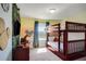 A cozy bedroom with a bunk bed and jungle-themed decor at 4841 Romeo Cir, Kissimmee, FL 34746
