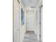 Hallway featuring white doors, neutral walls and carpeted floor at 4841 Romeo Cir, Kissimmee, FL 34746