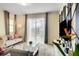 Bright living room with a view of the pool through sliding glass doors and stylish contemporary furniture at 4841 Romeo Cir, Kissimmee, FL 34746