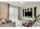 Stylish living room with contemporary furniture, modern TV display, and a view of the patio at 4841 Romeo Cir, Kissimmee, FL 34746