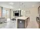 Contemporary living space featuring a large island, modern decor, and sleek tile floors at 4841 Romeo Cir, Kissimmee, FL 34746