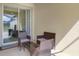Cozy outdoor patio with wicker furniture and access to the interior, great for relaxing and enjoying the weather at 4841 Romeo Cir, Kissimmee, FL 34746