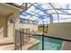 Screened in backyard pool area with lounge chairs and safety fence with blue sky background at 4841 Romeo Cir, Kissimmee, FL 34746