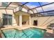 Backyard pool with a screened-in enclosure, providing privacy and a relaxing outdoor space at 4841 Romeo Cir, Kissimmee, FL 34746