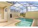 Relaxing pool area enclosed with a screen, featuring lounge chairs and clear blue water at 4841 Romeo Cir, Kissimmee, FL 34746