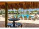 Resort-style pool area with ample lounge chairs, covered seating, and tropical views at 4841 Romeo Cir, Kissimmee, FL 34746