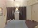 Serene bedroom featuring a soft bed and calming decor for restful nights at 50989 Highway 27 # 130, Davenport, FL 33897