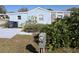 Blue single-story home featuring tidy landscaping, and a grassy front yard at 50989 Highway 27 # 130, Davenport, FL 33897