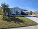 Charming home with a carport and well-maintained lawn and a palm tree in a desirable neighborhood at 50989 Highway 27 # 130, Davenport, FL 33897