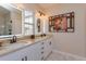Bathroom with double sinks, tan marble countertops, and modern lighting at 528 Lobelia Dr, Lake Mary, FL 32746