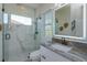 Bathroom with a glass shower, marble countertops, and a modern mirror at 528 Lobelia Dr, Lake Mary, FL 32746