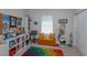 Bright bedroom featuring a colorful rug, a cozy couch, and plenty of storage space at 528 Lobelia Dr, Lake Mary, FL 32746